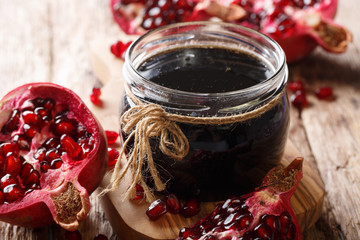 Azerbaijani seasoning Narsharab sauce made from pomegranate juice in a jar close-up. horizontal