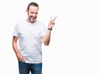 Middle age hoary senior man wearing white t-shirt over isolated background smiling with happy face winking at the camera doing victory sign. Number two.