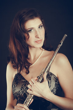 Elegant woman with flute instrument.