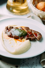 Sliced beef and marbled beef steak with garnish. Restaurant dish for the menu.