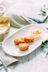 Chicken and cheese nuggets with sauce. Restaurant dishes with a beautiful serving.