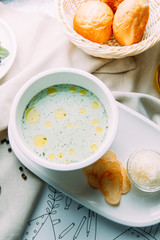 Soup with greens, mushrooms and noodles with chicken. Restaurant dishes with a beautiful serving.