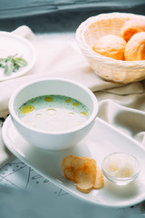 Soup with greens, mushrooms and noodles with chicken. Restaurant dishes with a beautiful serving.