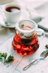 Fruit tea in a teapot with decor. Restaurant dishes with a beautiful serving.