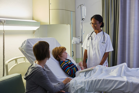 Female doctor visiting a child patient in a hospital room