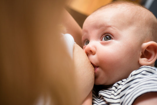 Baby looking at mother while breastfeeding