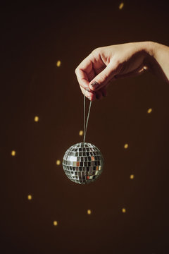 Hand holding a mirror ball