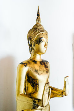 Golden statue with exfoliated paint
