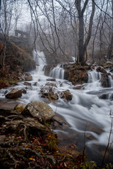little waterfalls in rainy autumn forest