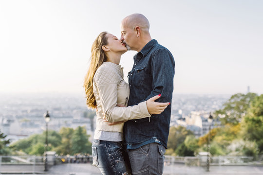 Couple in Montmartre with panoramic view of Paris