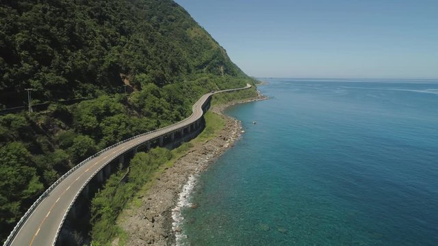 Aerial view of Patapat viaduct in the coast of Pagudpud, Ilocos Norte. Highway with bridge by coast sea near the mountains. Philippines, Luzon.