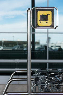 Sign showing carts for luggage in airport