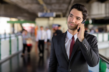 Portrait of businessman in city talking on mobile phone