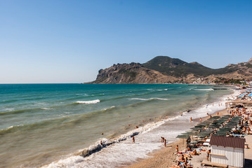 Crimea. Black Sea. Nude beach in Koktebel. View of the mountain Kara-Dag.