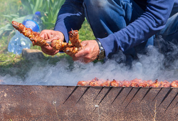 Kebab on sticks fried on coals in nature