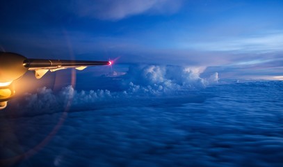 Fototapeta na wymiar aerial view from window of an airplane. Cloud surfing early morning 