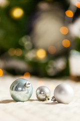 Three Pearl Christmas balls with colorful bokeh