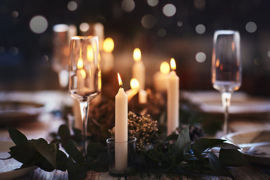 cosy table setting with candles for dinner party 
