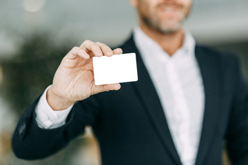 Credit card in the businessman's hand. Rod designer, cut out the background.