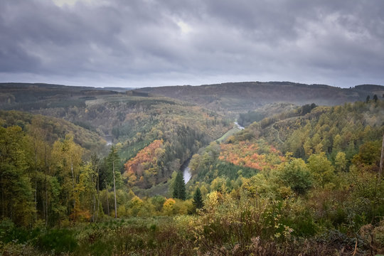 Moody and dark panorama of an Ardennes valley with Ourthe shaping the landscape