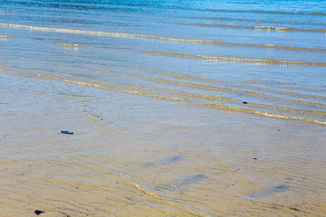 Small waves on a tropical Queensland beach in Australia