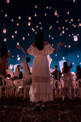 young woman release white lantern in the sky, Chiang Mai Thailand white lantern to release in the sky during Loi Krathong Yee Peng Festival