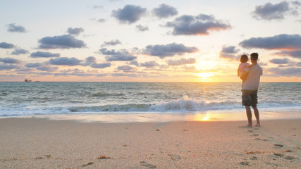 Father and daughter on sea beach