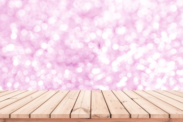 Wood table or wood floor with abstract pink bokeh background for product display