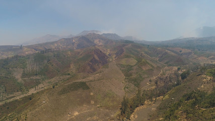 Mountain hilly landscape in rural areas with agricultural land in Java Indonesia. aerial view slopes mountains covered with vegetation. mountain landscape