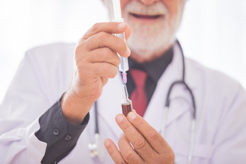 Doctor Men using syringe Injection for patients.