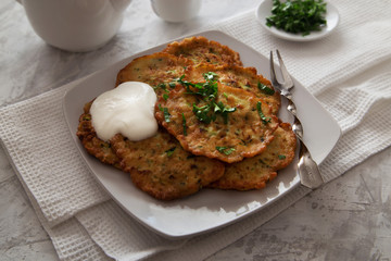 Vegetable pancakes with sour cream and parsley