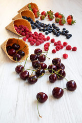 Waffle sweet ice cream cones with raspberries, cherries, strawbe