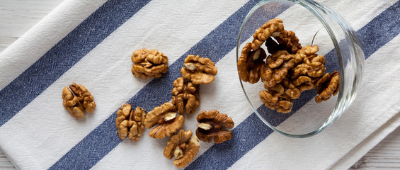 Walnuts in glass bowl, top view. Closeup. Overhead, from above.