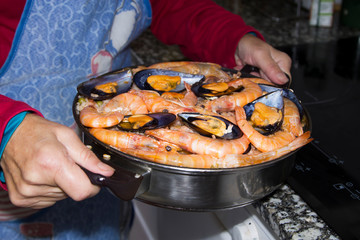 cooking rice with seafood, paella marinera