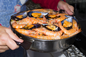 cooking rice with seafood, paella marinera