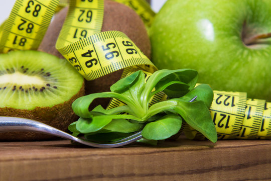 fruits and vegetables with tape measure, concept of diet and health