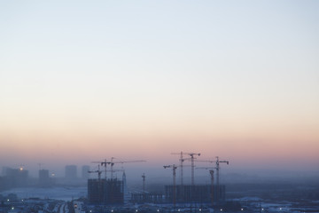 Fototapeta na wymiar Construction of the building at dawn. Background the city of industry.