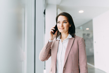 Girl blogger calls on the phone and agrees. Emotional portraits at work.