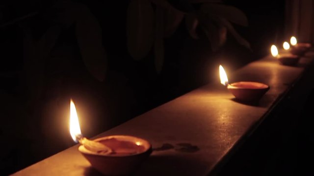 night dolly shot of hindu traditional oil lamp lights called diyo during hindu traditional festival dipawali