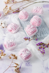  fruit marshmallow homemade on a soft pink background and dried flowers