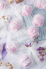  fruit marshmallow homemade on a soft pink background and dried flowers