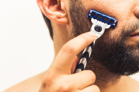 Cropped image of a beard man holding razor and about to start shaving