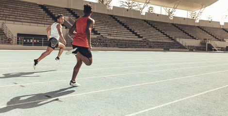 Athletes running a race in a track and field stadium