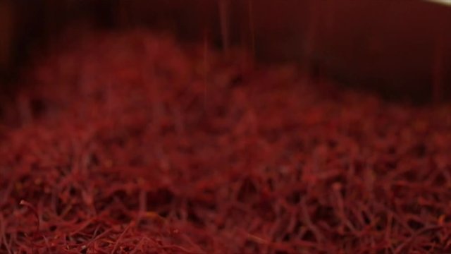 Saffron threads are raining down, a saffron pile is growing, Closeup