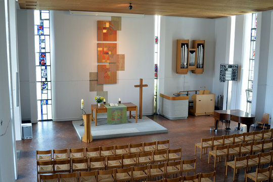 Paul-Gerhardt-Kirche in Plochingen with interior (nave), altar, crucifix and  artistic formed windows
