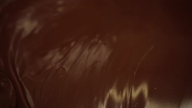 Chocolate is conched while picture rotates, Closeup