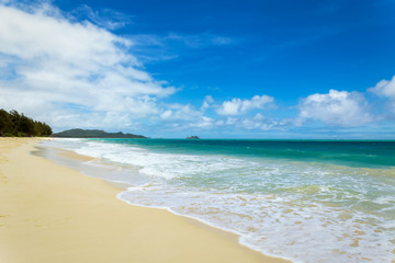 Fototapeta na wymiar Beautiful Waimanalo beach with turquoise water and cloudy sky, Oahu coastline, Hawaii