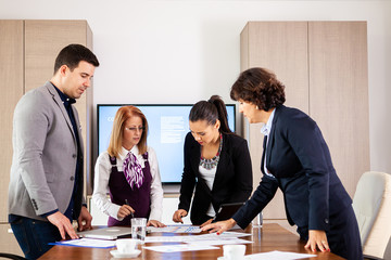 Manager discussing work with his colleagues in conference room. Getting results.