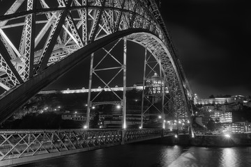 view of the bridge dom luis at night in porto city of portugal in black and white