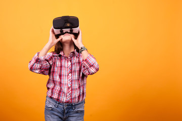 Little girl having fun while she has her VR on. Studio photoshoot